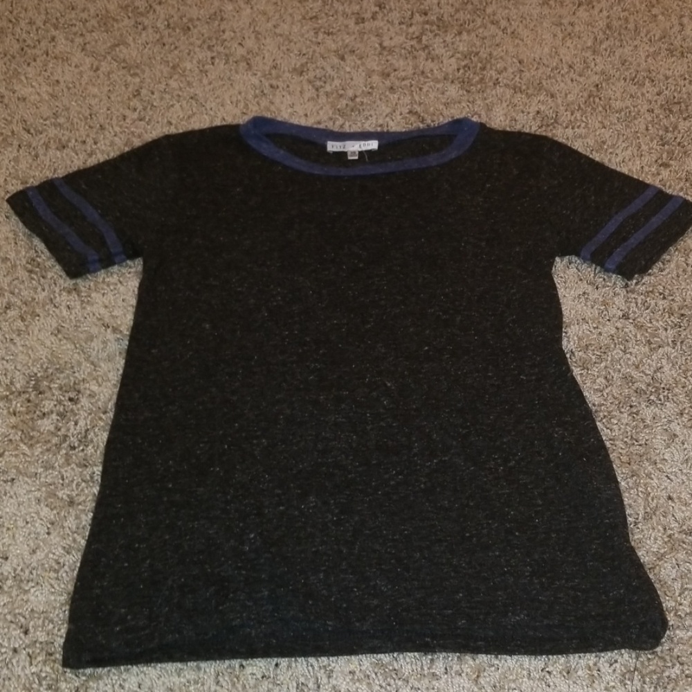 Black shirt with blue stripes on arm.